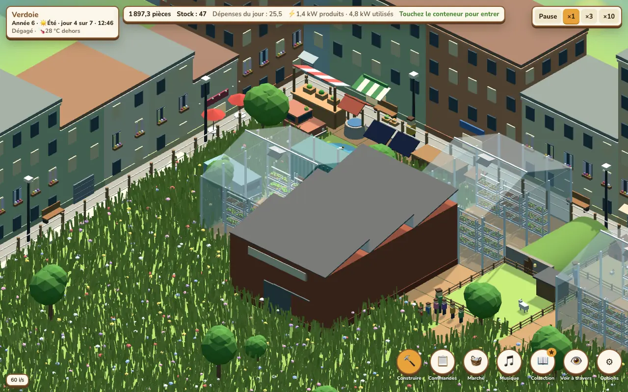 The container farm and its greenhouses in a meadow, city blocks behind
